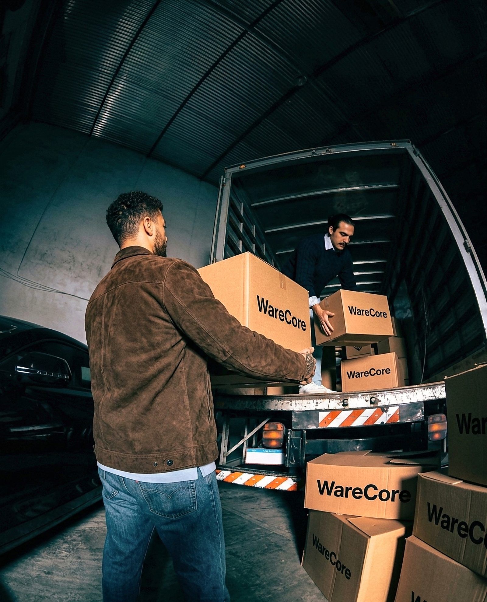 Ahmed and Hossam loading WareCore boxes onto a truck
