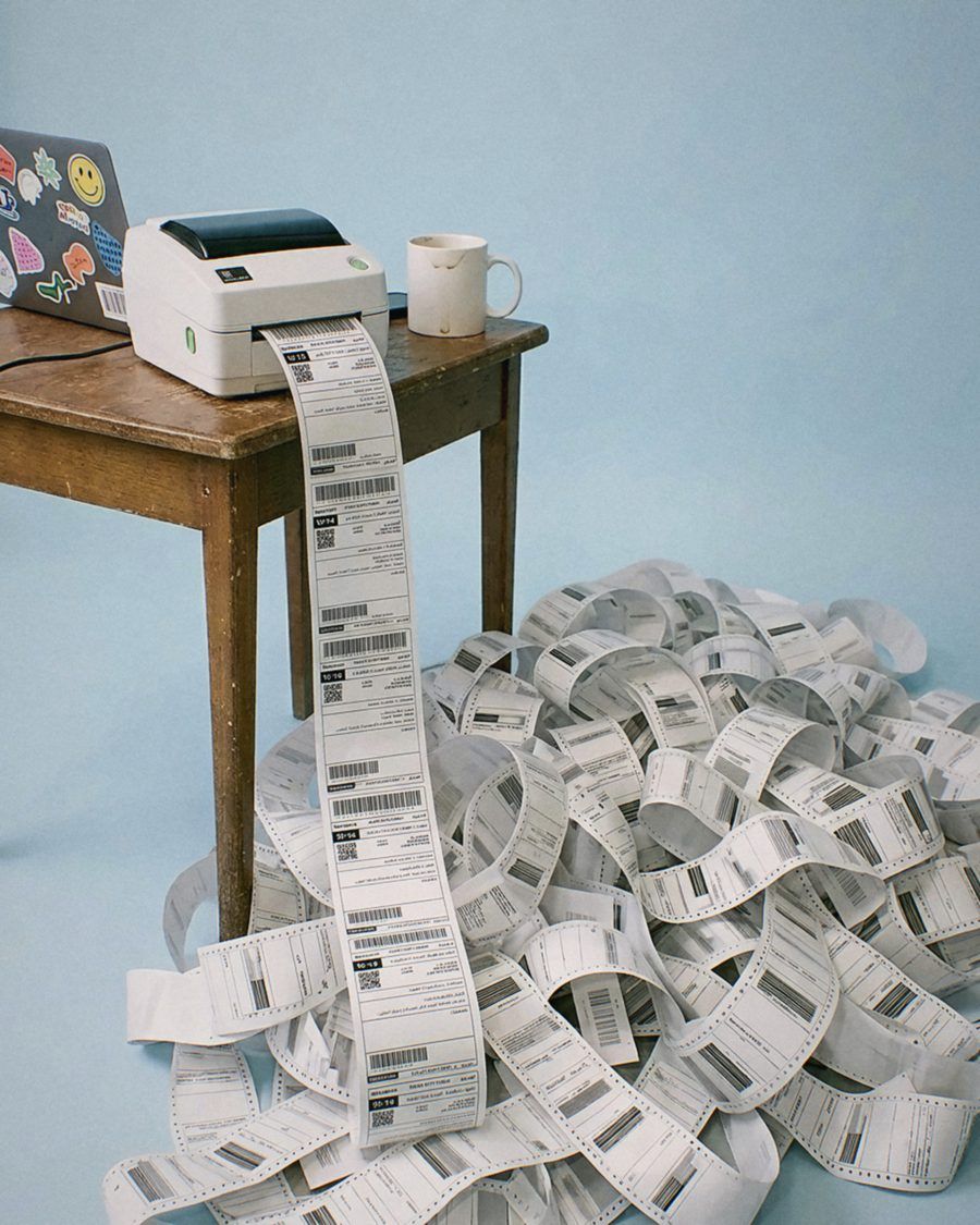 A label printer pouring shipping labels onto the floor