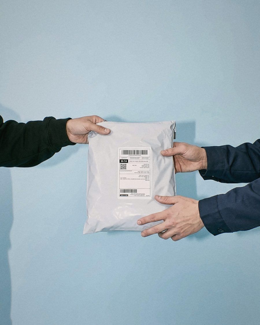 A courier mailer handed between two hands