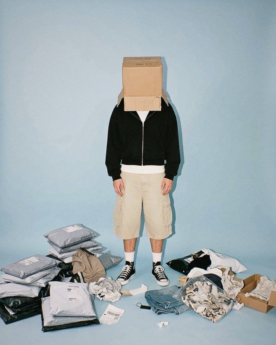 A founder with a box over his head among returned parcels